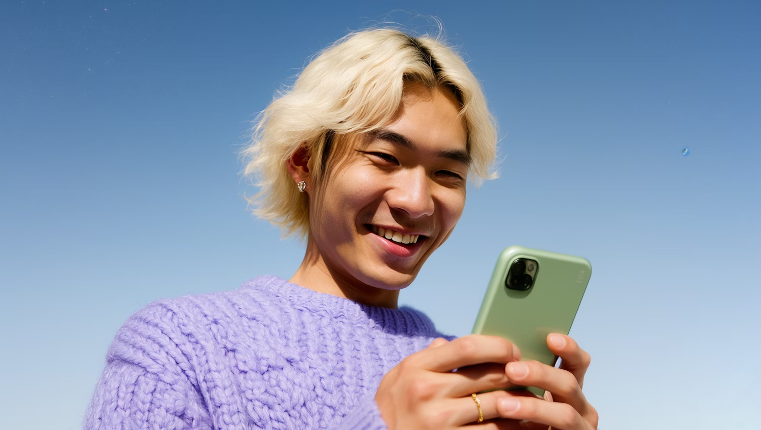 Person smiling while using Niftipay on phone